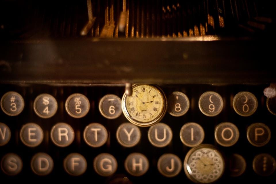 Clock over typewriter